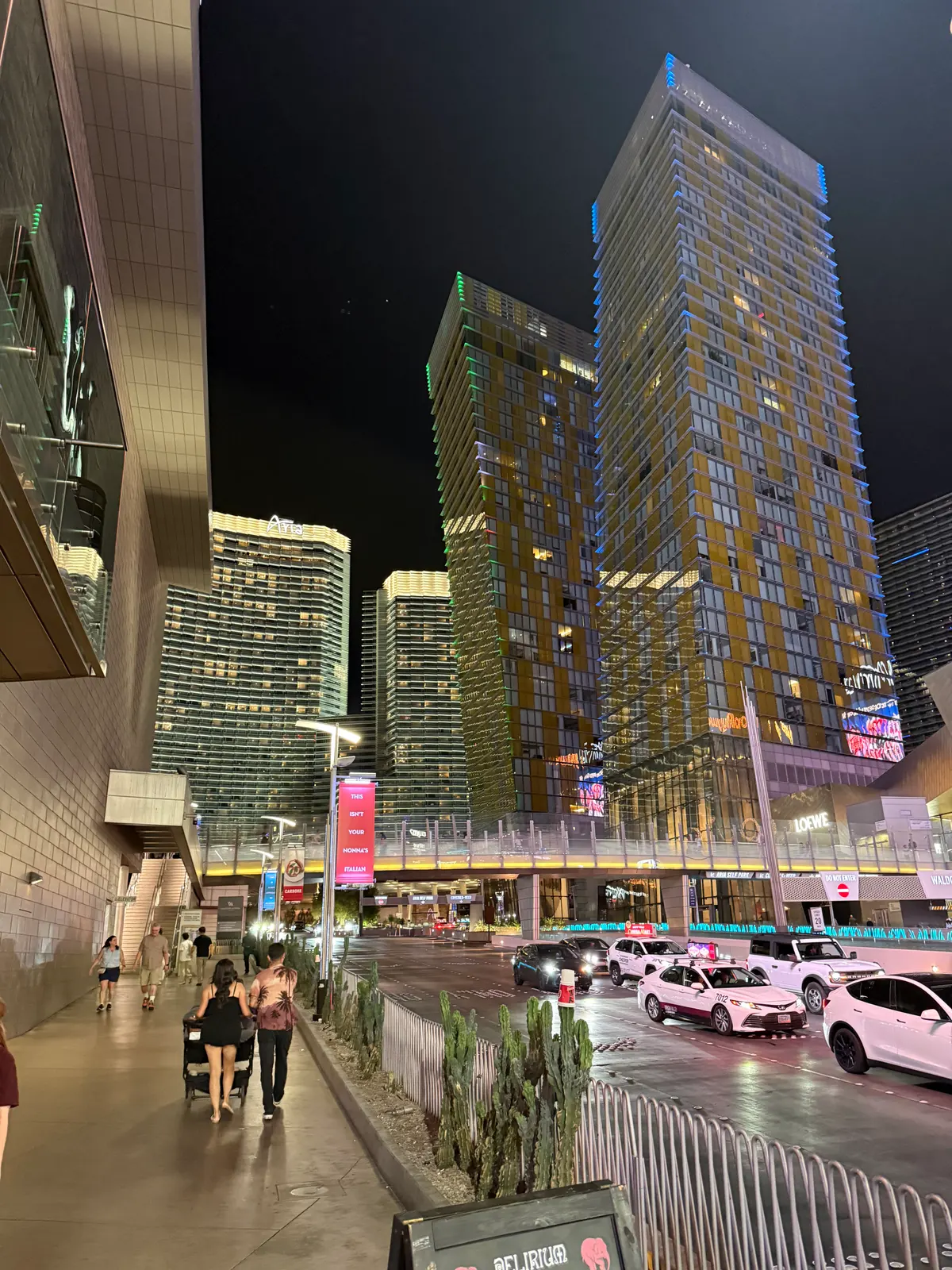ARIA in the background beyond the foreground CityCenter towers at night, photographed in 2026